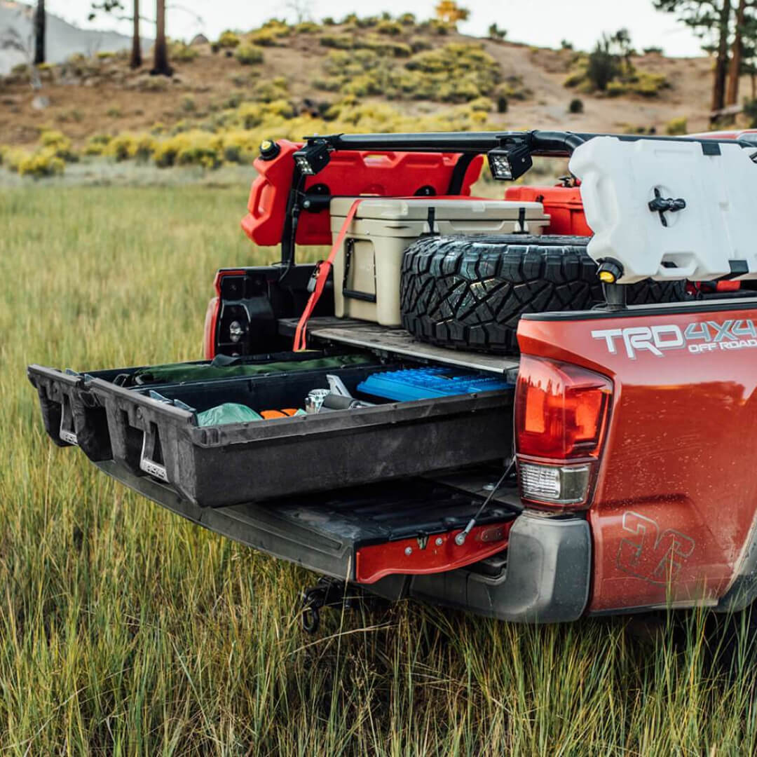 Side view of a Full-size Drawer System open in the back of a red truck