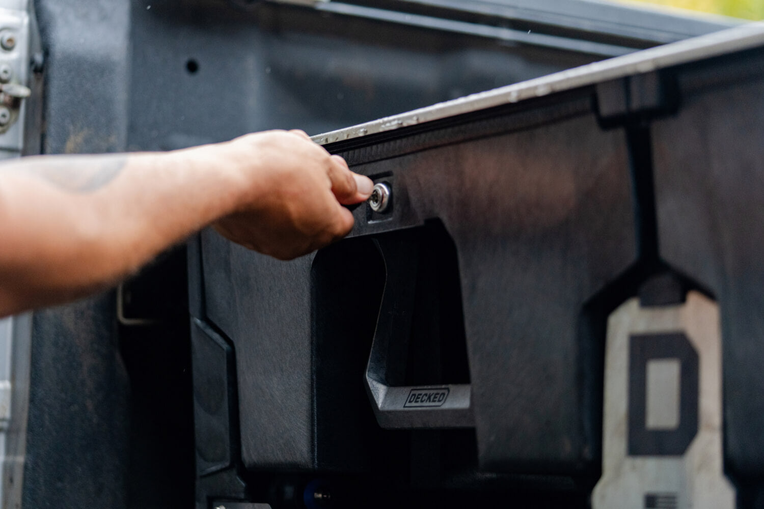 A person locking their Drawer System's Drawer Locks accessory.