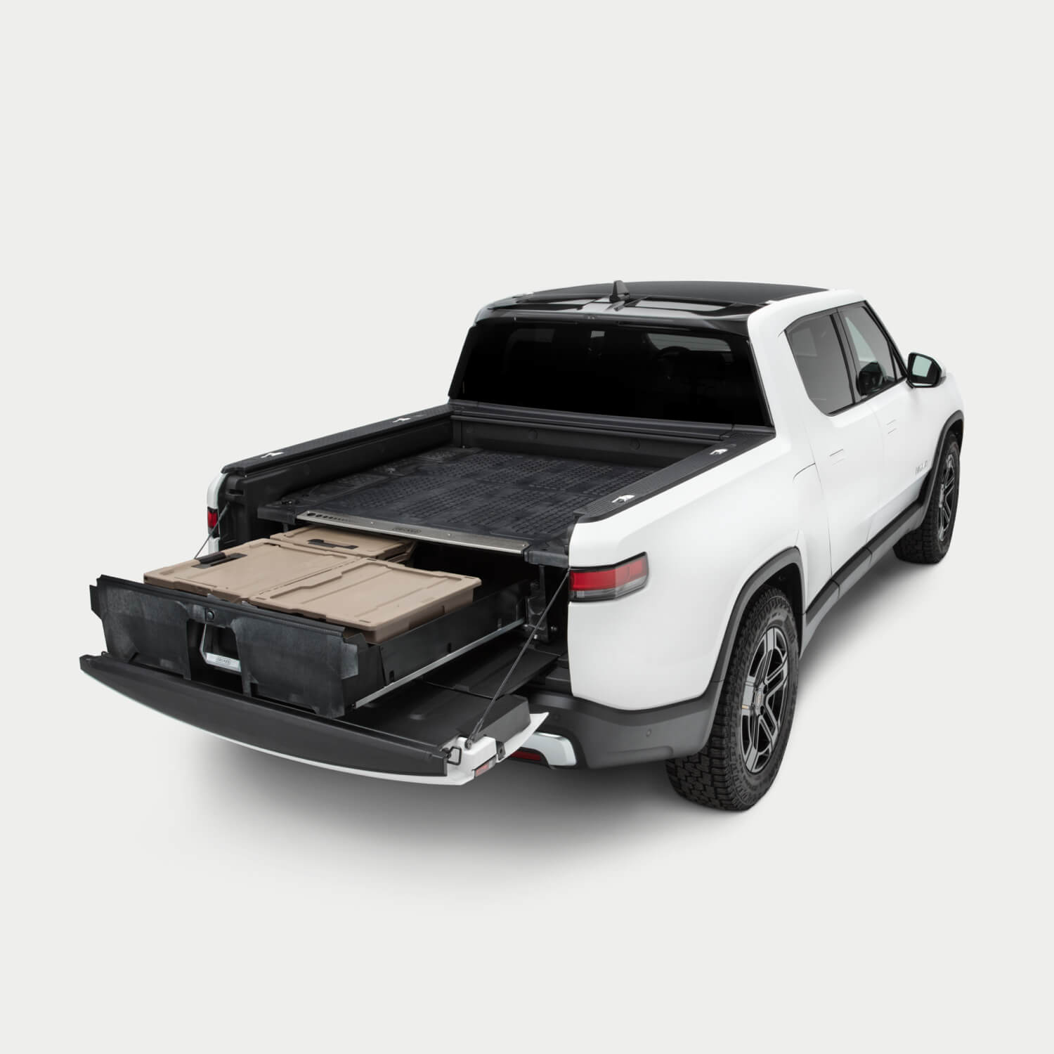 Side angle view of a Drawer System installed in a Rivian R1T with the drawer open and one Sixer, a Halfrack, and a Payloader D-co case inside.