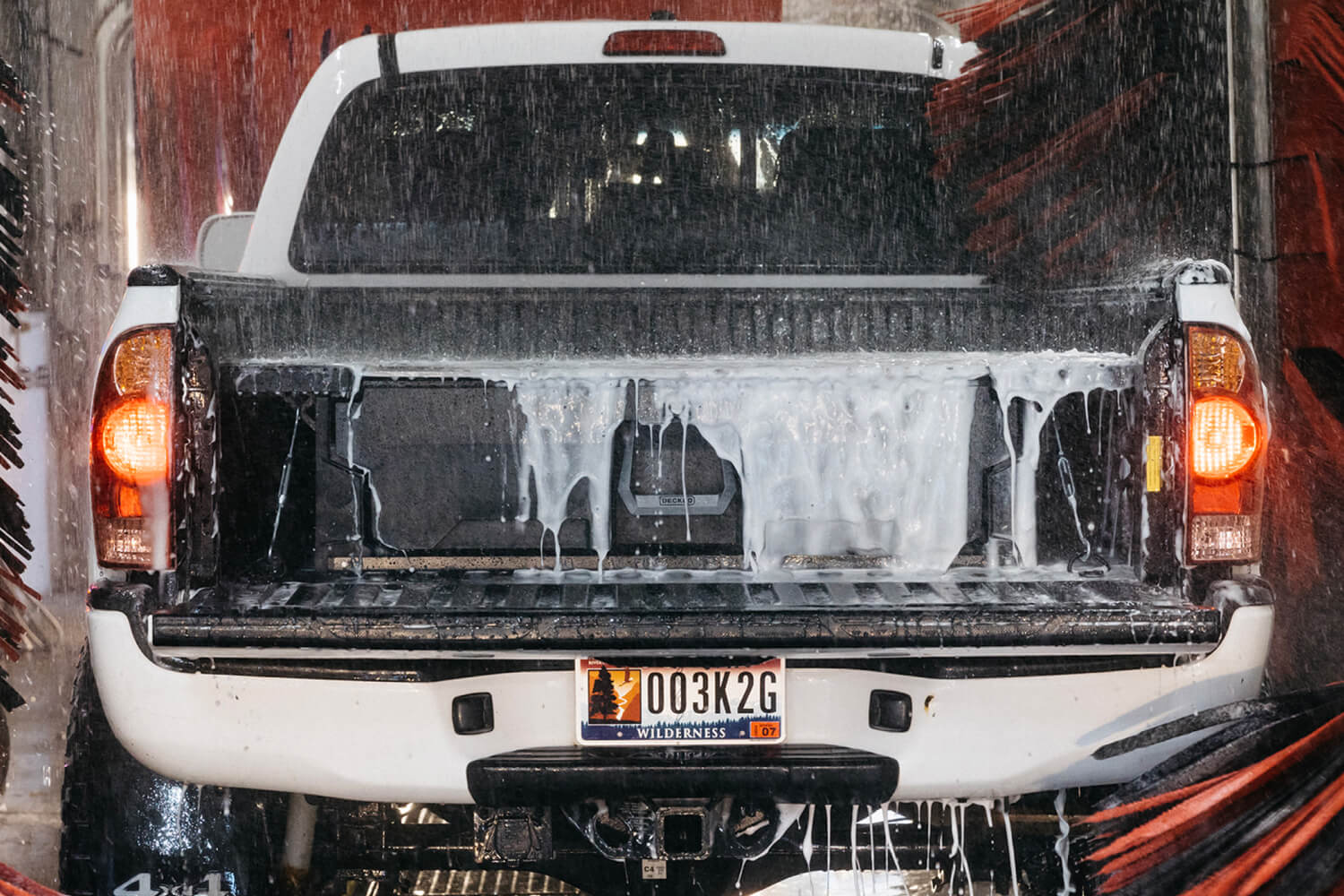 A drenched and soapy drawer system going through the car wash.