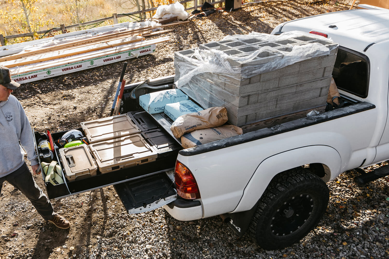 A man unloading a pallet of cinder blocks off of his drawer system.