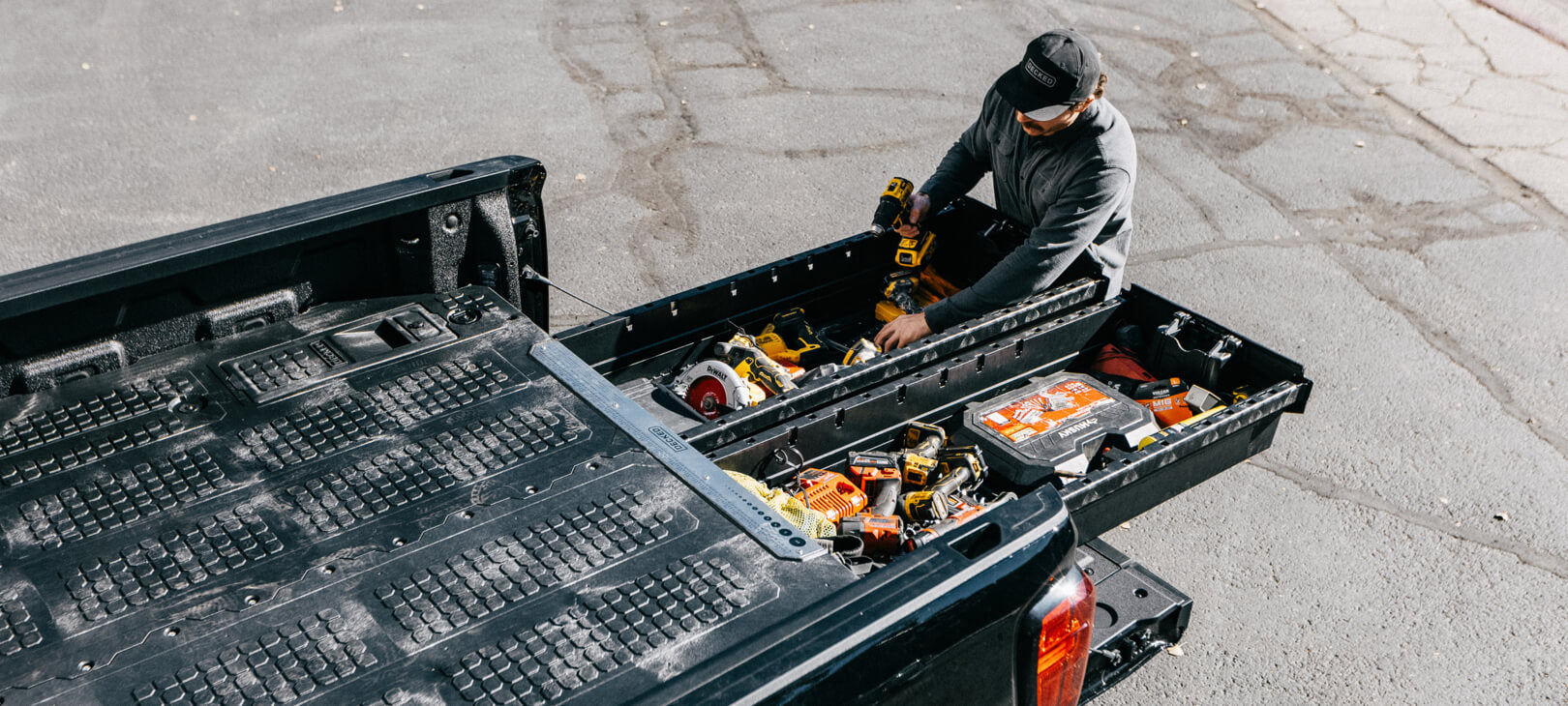 A man retrieving tools from his Drawer System.