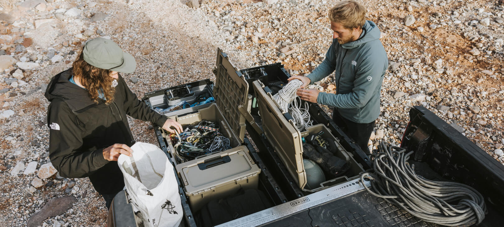 A couple of climbers retrieving ropes and other equipment from their Drawer System.