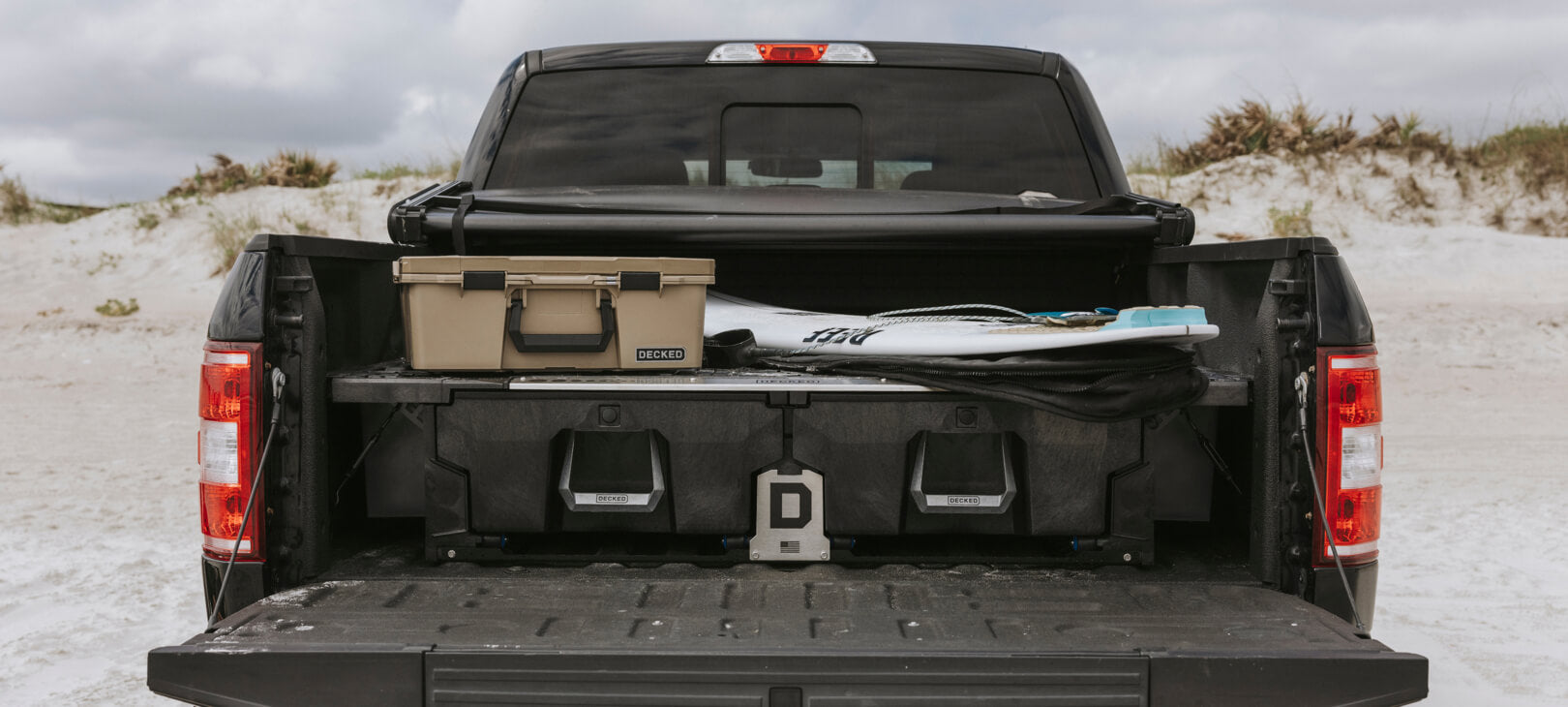 A closed Drawer System with a surfboard and D-co Case sitting on top of the deck.