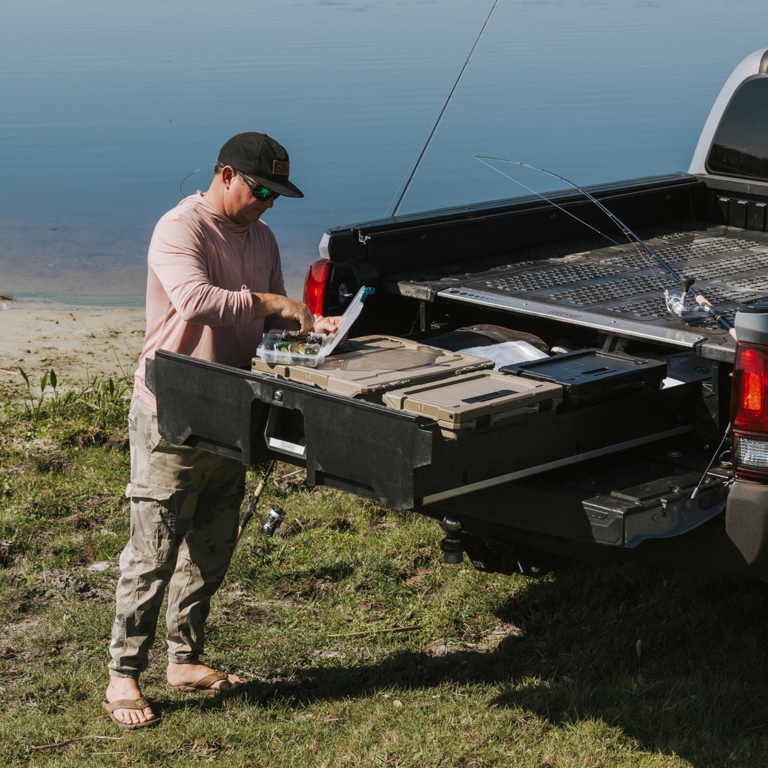 A fisherman looking through his fly box with the rest of his gear packed neatly in his Drawer System.