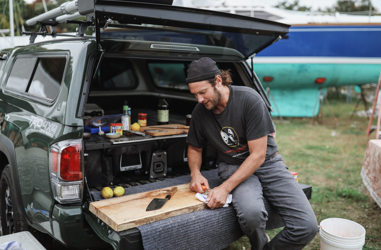 Man using his tailgate as a cooking platform