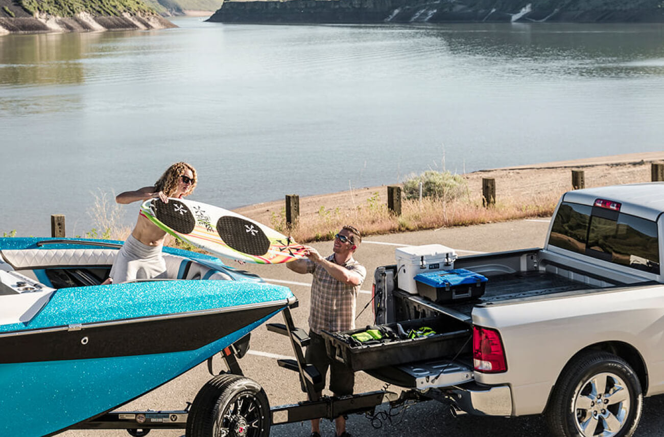 truck pulling a surfing boat and a drawer system storing boating gear