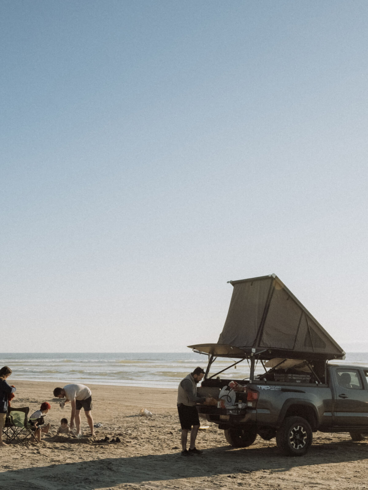 family truck camping on a beach