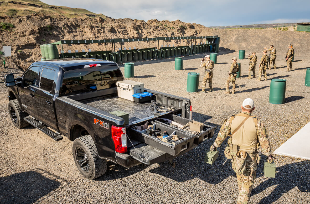 back of truck with a decked drawer system organizing tactical gear at a gun range
