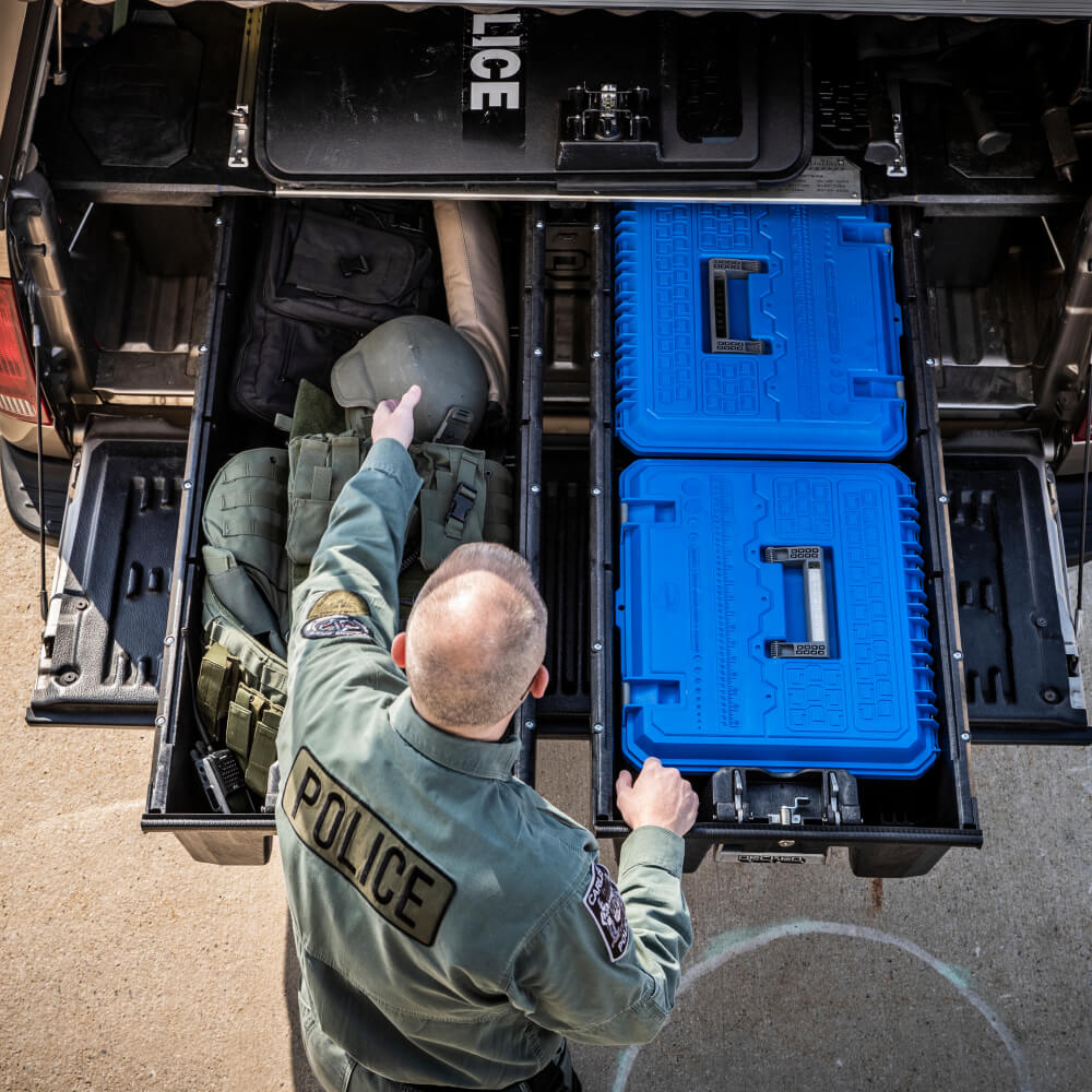 Overhead view of a police officer accessing his tactical gear in his drawer system