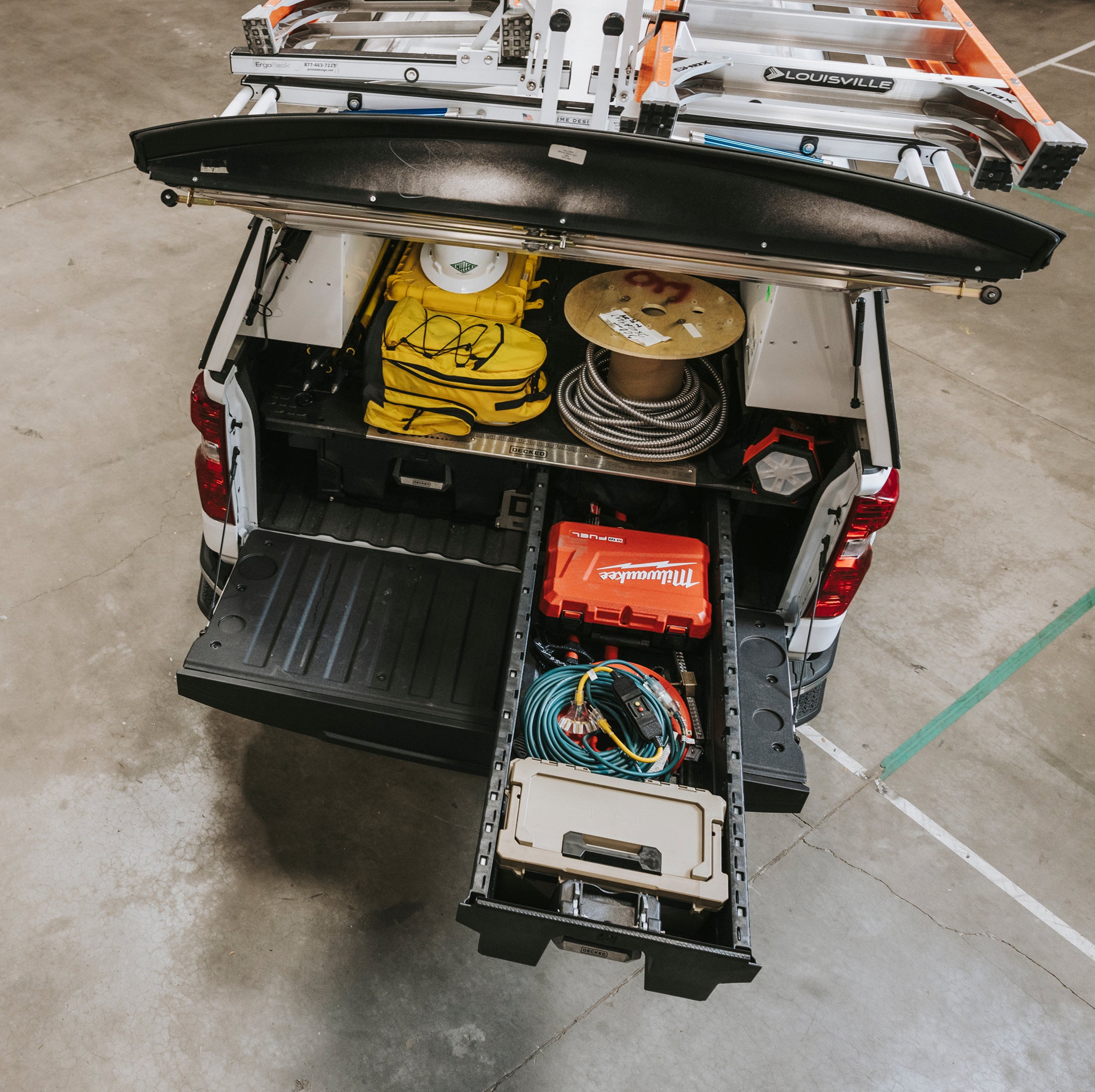 Truck bed with DECKED Drawer System storage compartments and tools on a concrete floor