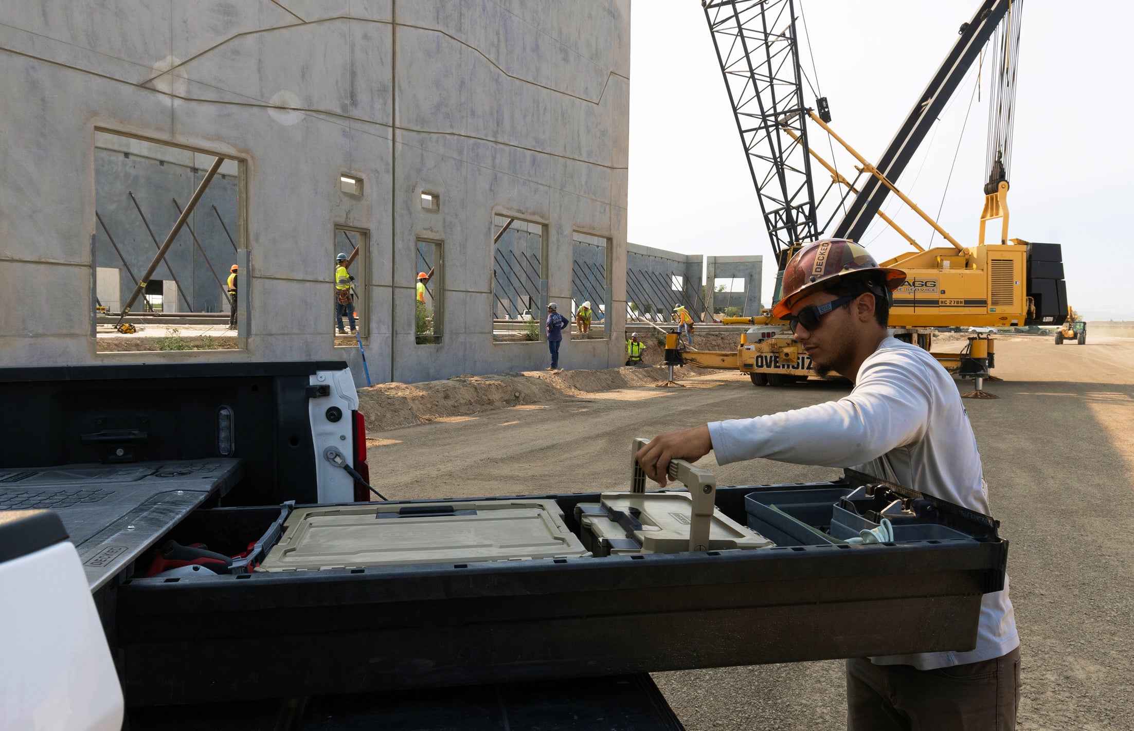 Man working out of a DECKED Drawer System with a construction site in the background