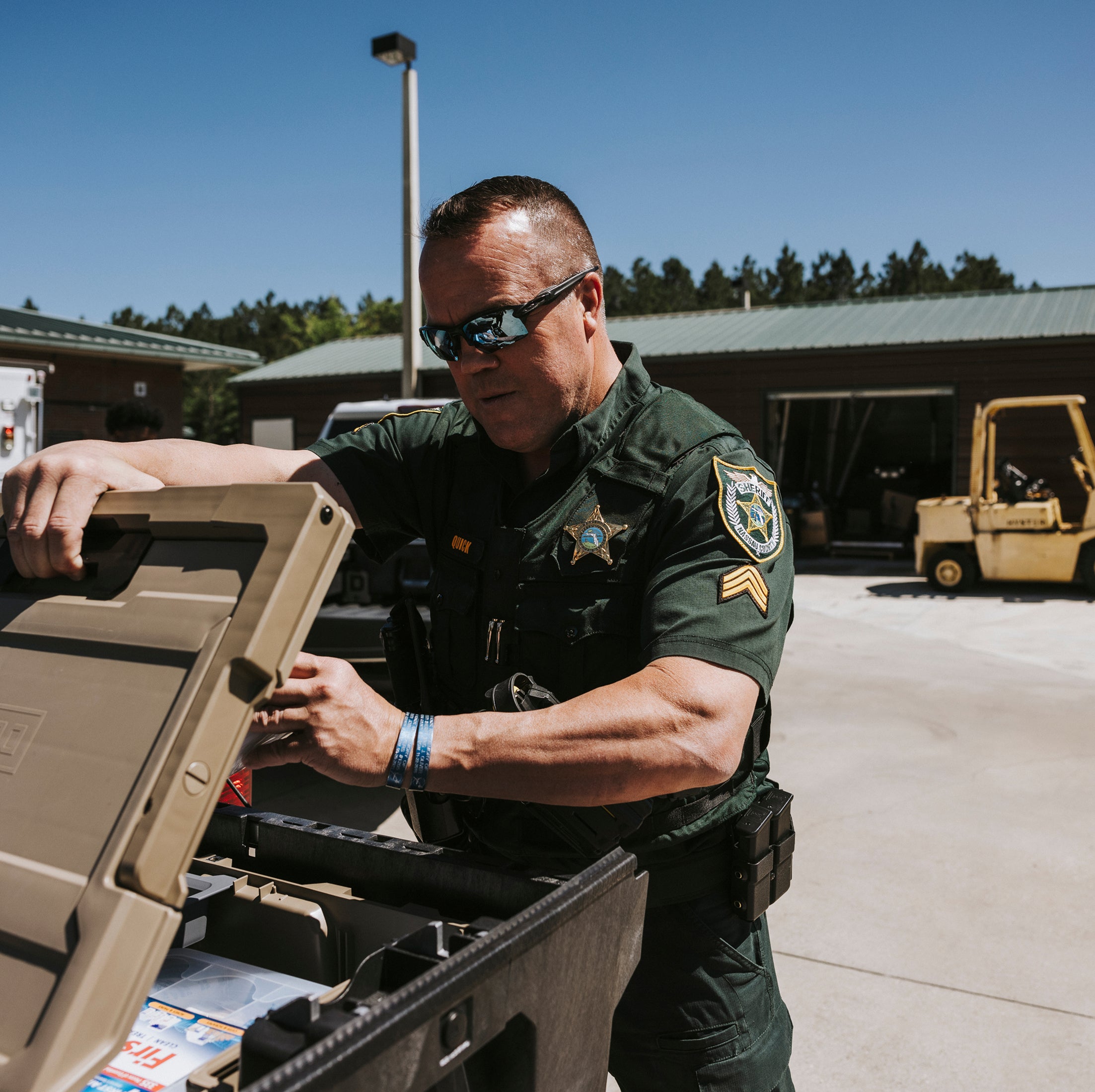 Officer in uniform opening a Halfrack 32 protective case.