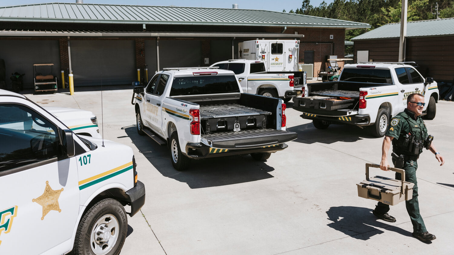 Law enforcement vehicles and personnel at a station.