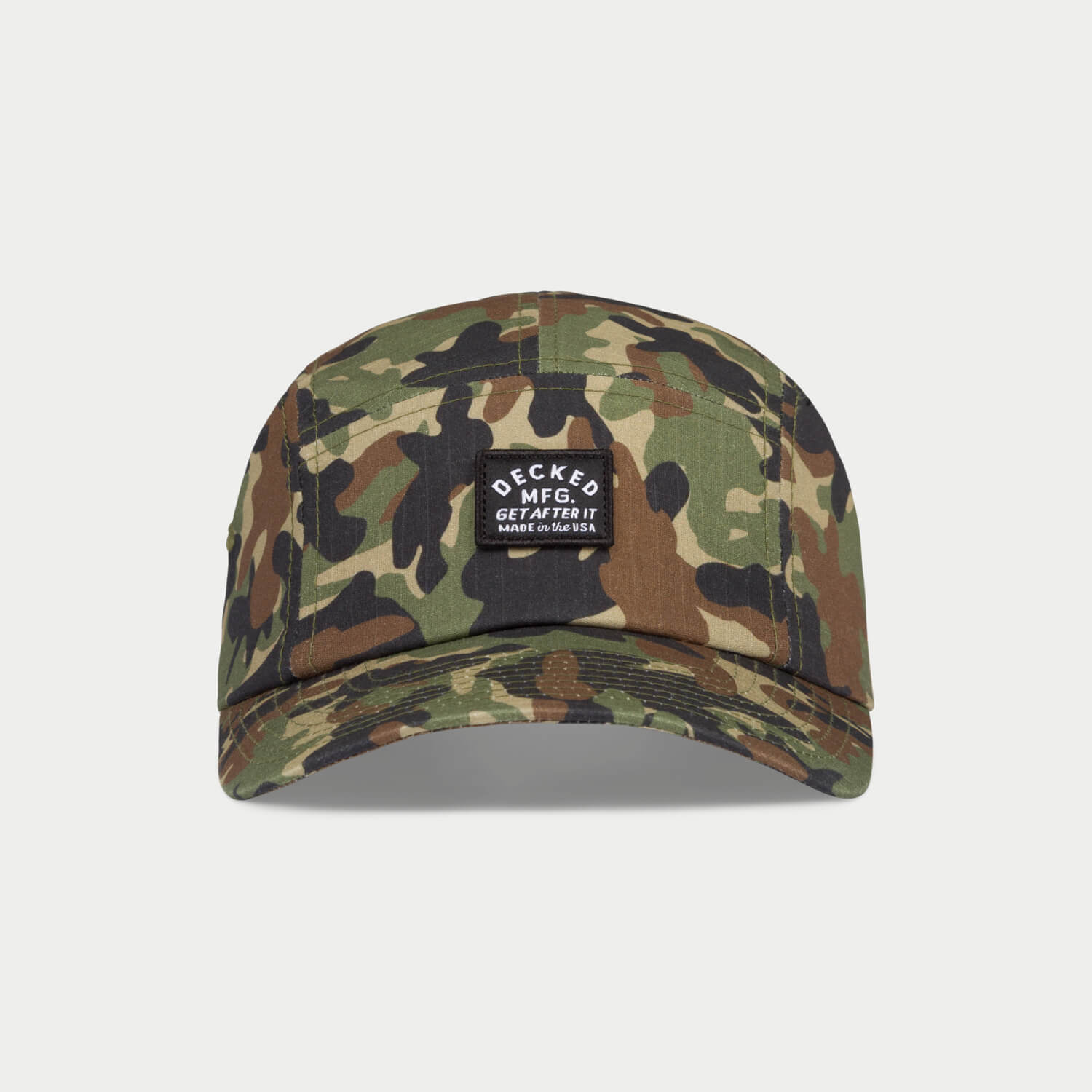 [H0113-PNL5-CMO] A green, brown and black 5-panel hat that has a small DECKED patch that says GET AFTER IT and Made in the USA.