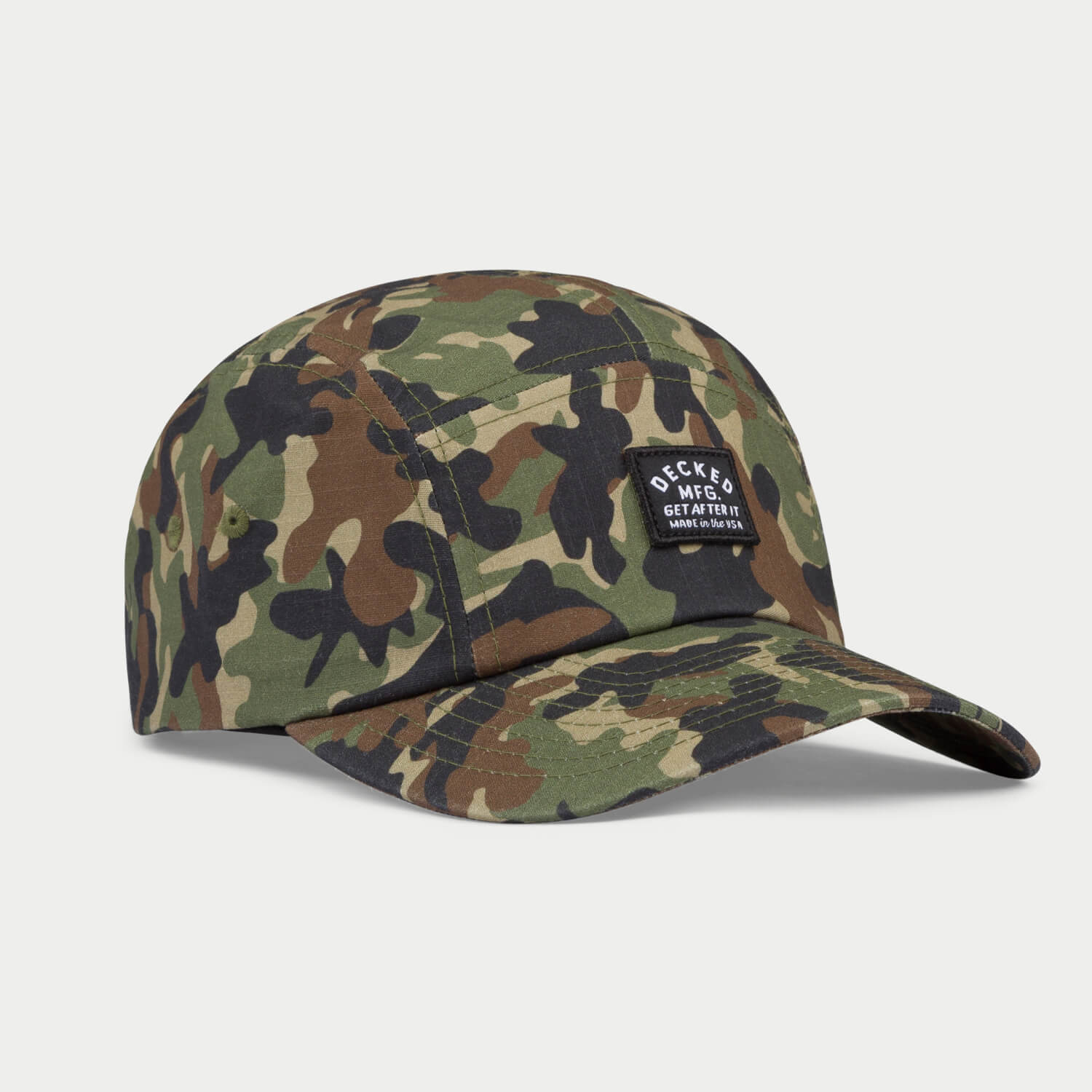 [H0113-PNL5-CMO] An angled green, brown and black 5-panel hat that has a small DECKED patch that says GET AFTER IT and Made in the USA.