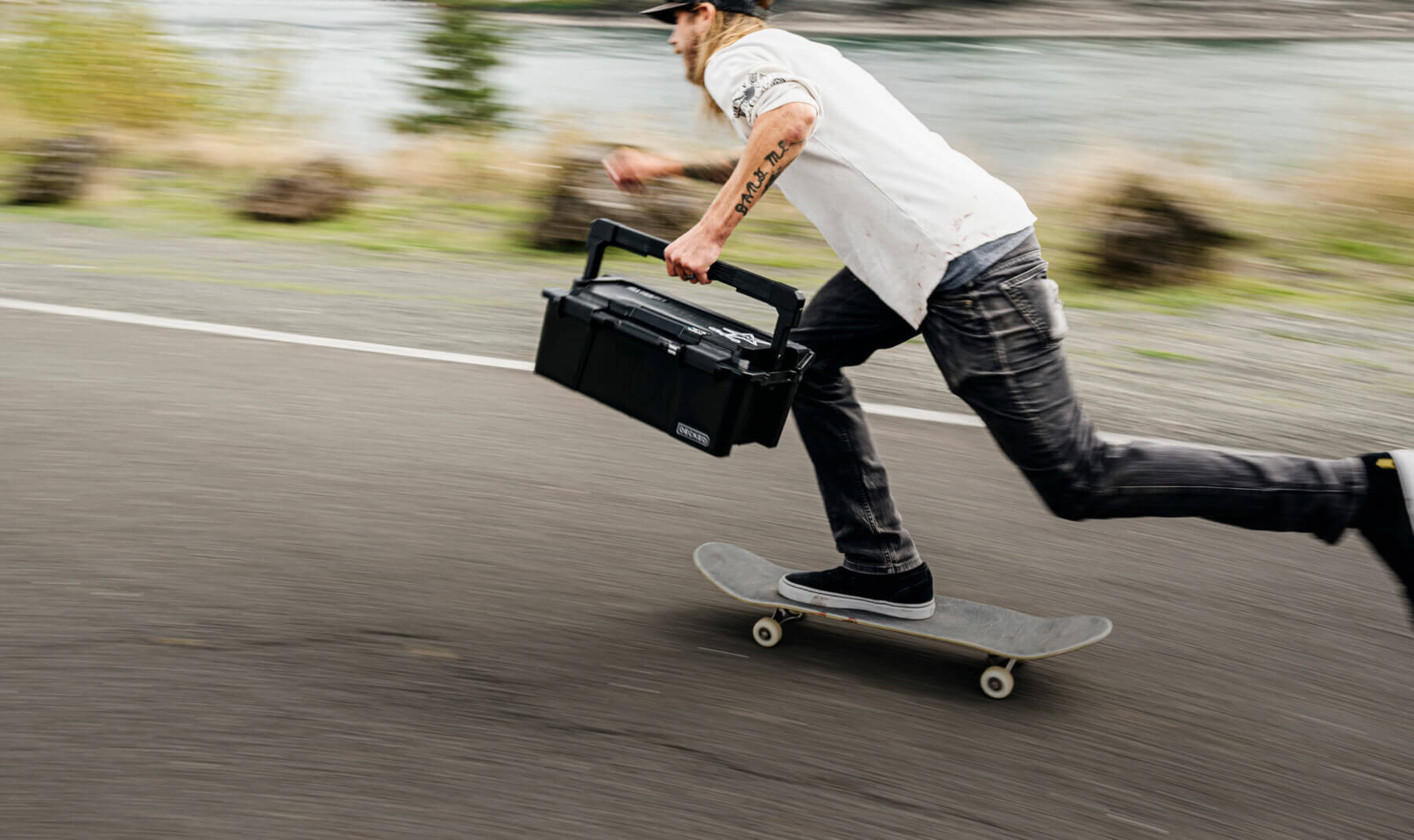 David Gravette skating at speed, holding onto his Sixer D-co Case that organizes all the gear he needs.