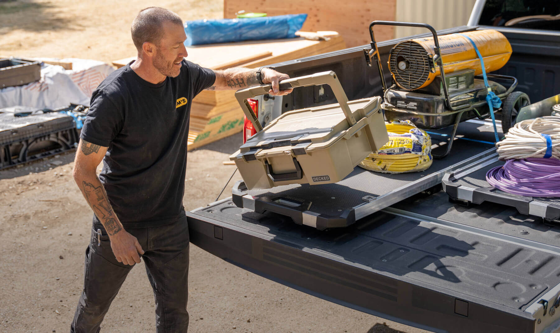 Zeban from Tim's Electric pulling his D-co Case off of his CargoGlide 600 bed slide system in his work truck.