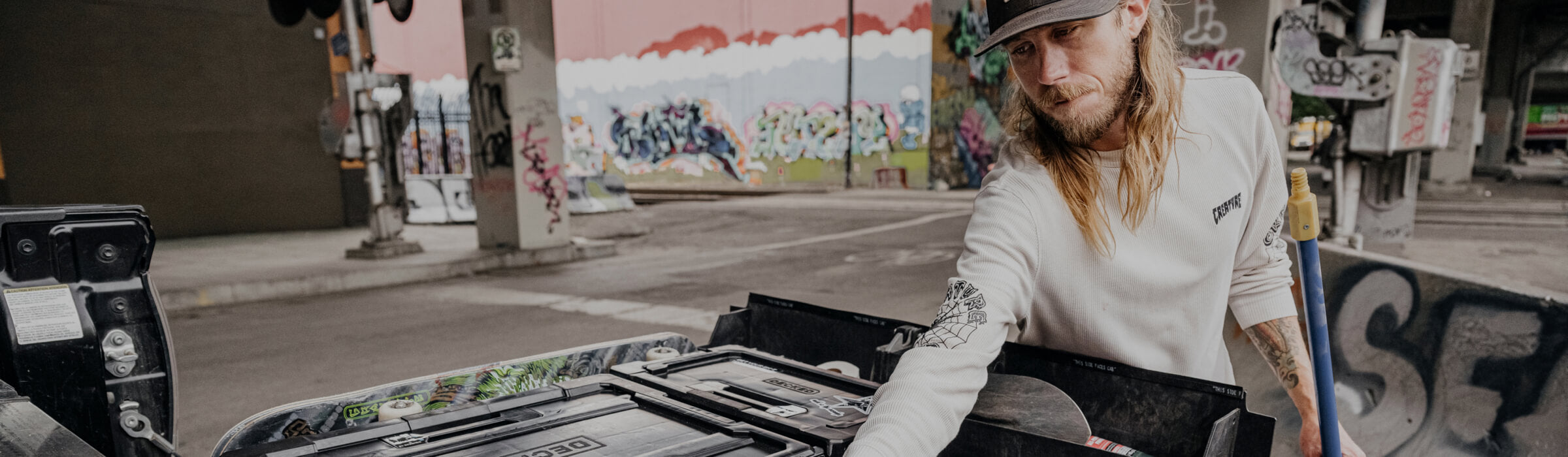 David Gravette at an urban skate park pulling gear out of his Drawer System.