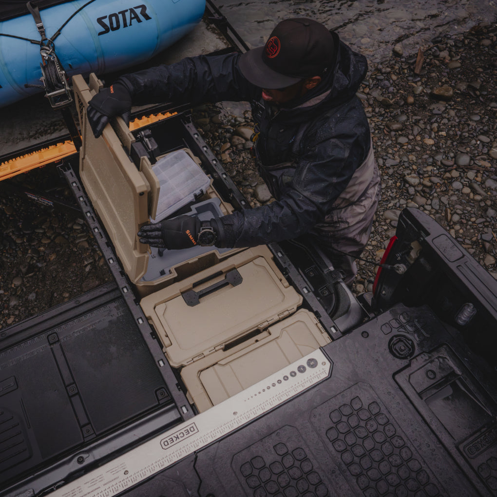 Lael Johnson carrying his Sixer D-co Case through the shallows to get to his boat.