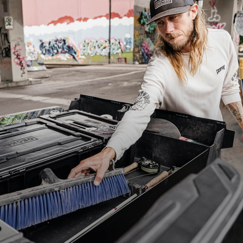 David Gravette at an urban skate park pulling gear out of his Drawer System.