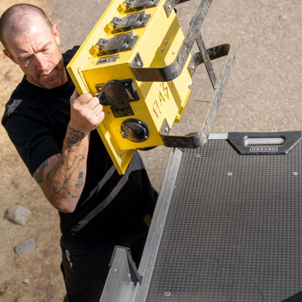 Zeban from Tim's Electric pulling gear off of his CargoGlide 600 bed slide system in his work truck.