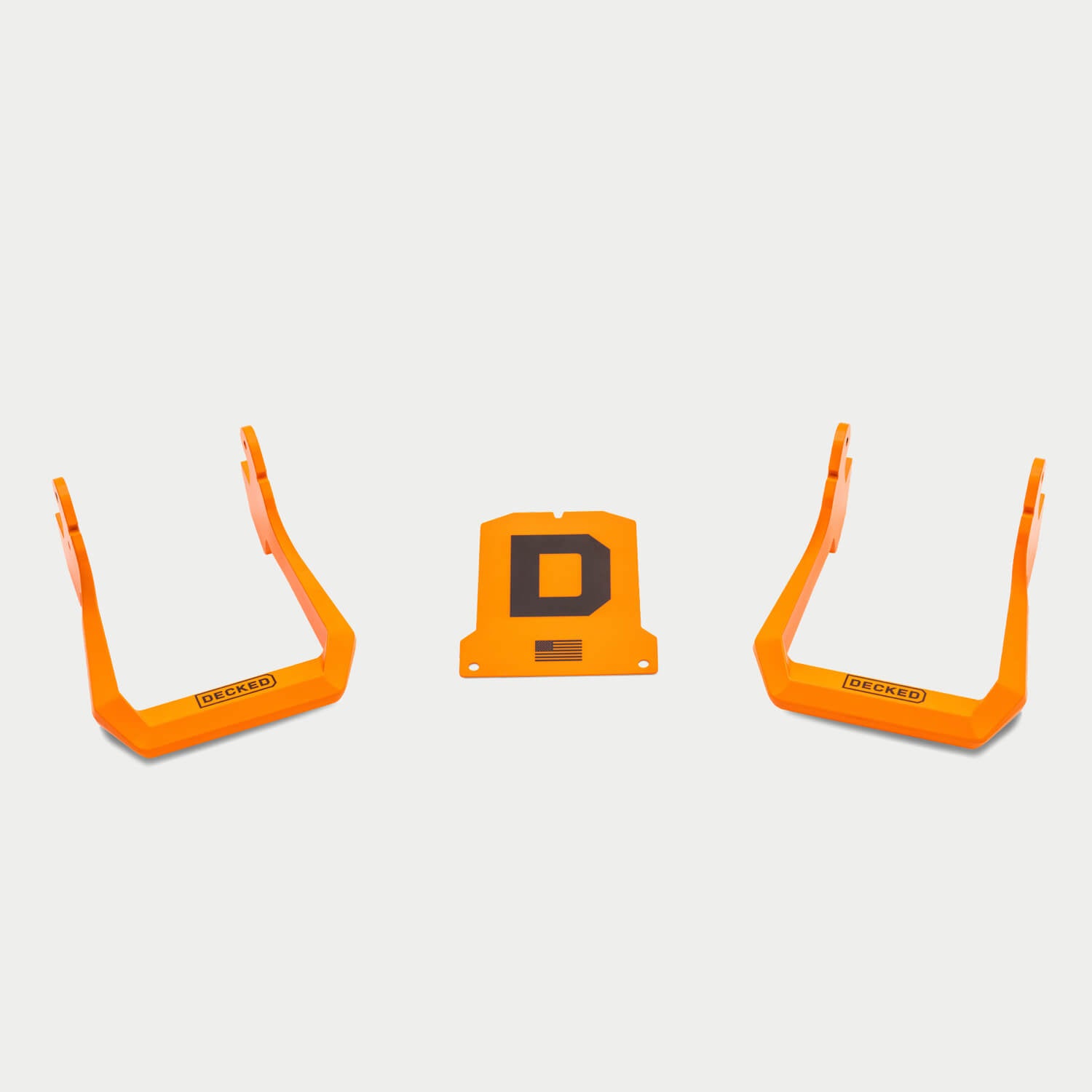 [S0003-XHOP-ONG] Two orange DECKED Drawer System handles and a COD Piece that goes on the center of a Drawer Syste with a black 'D' logo on a light gray background.