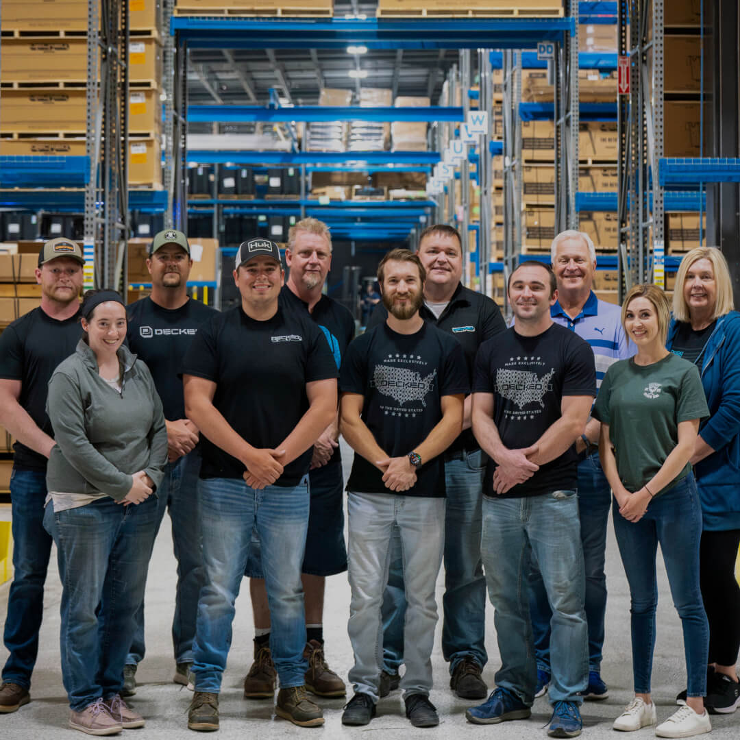 A bunch of workers standing together at the DECKED factory