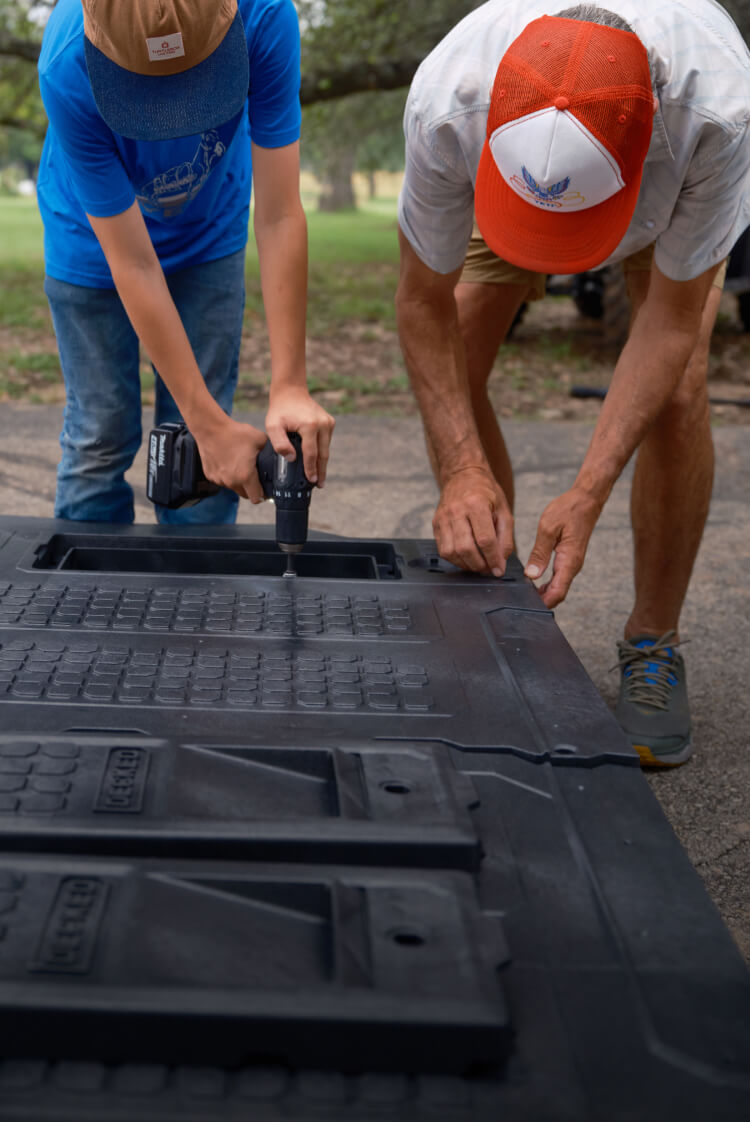 JT VanZandt and his son assembling a drawer system.