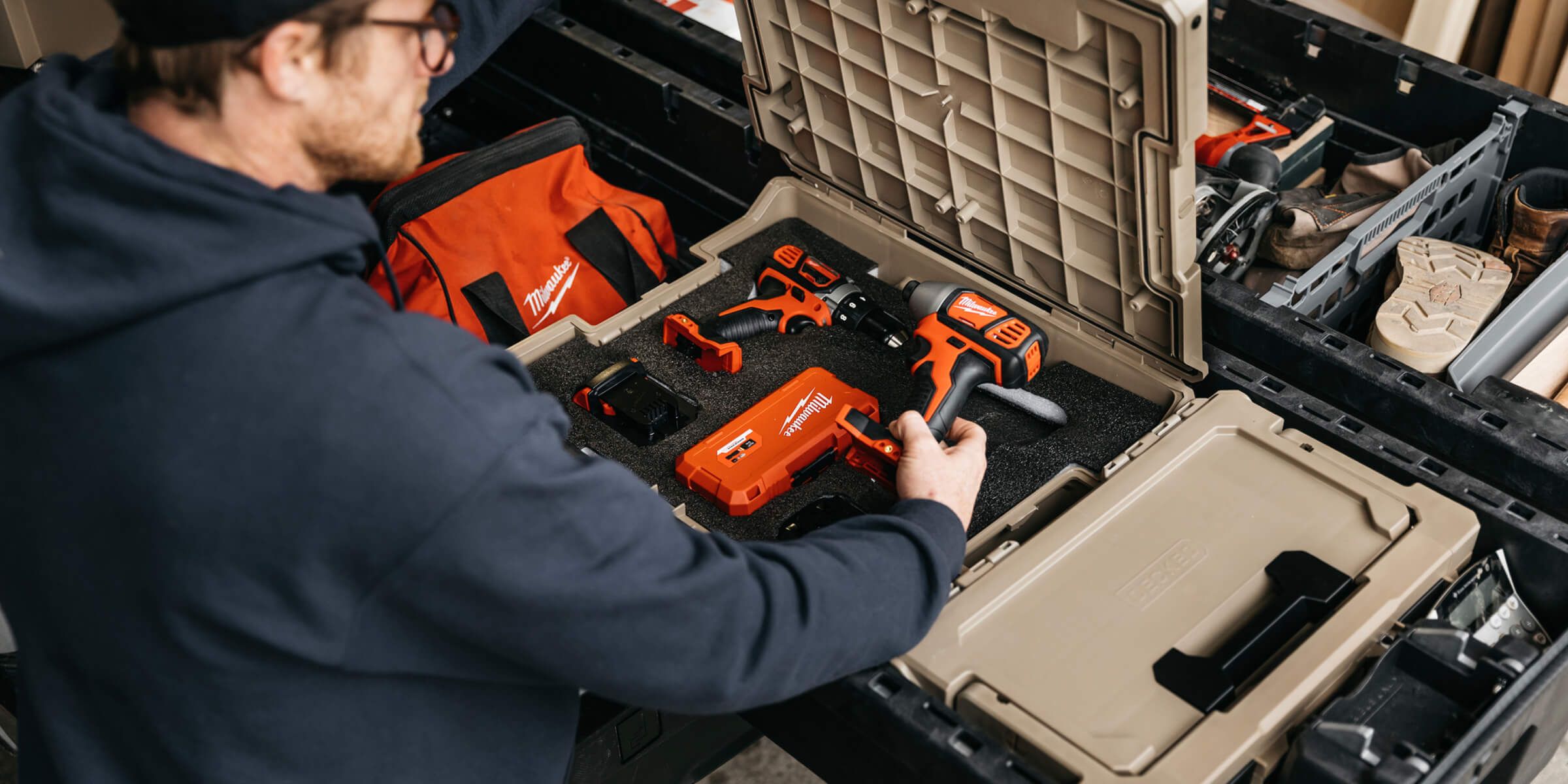 A man pulling his tools, neatly organized by a Halfrack D-co Case with foam insert, from his DECKED Drawer System.