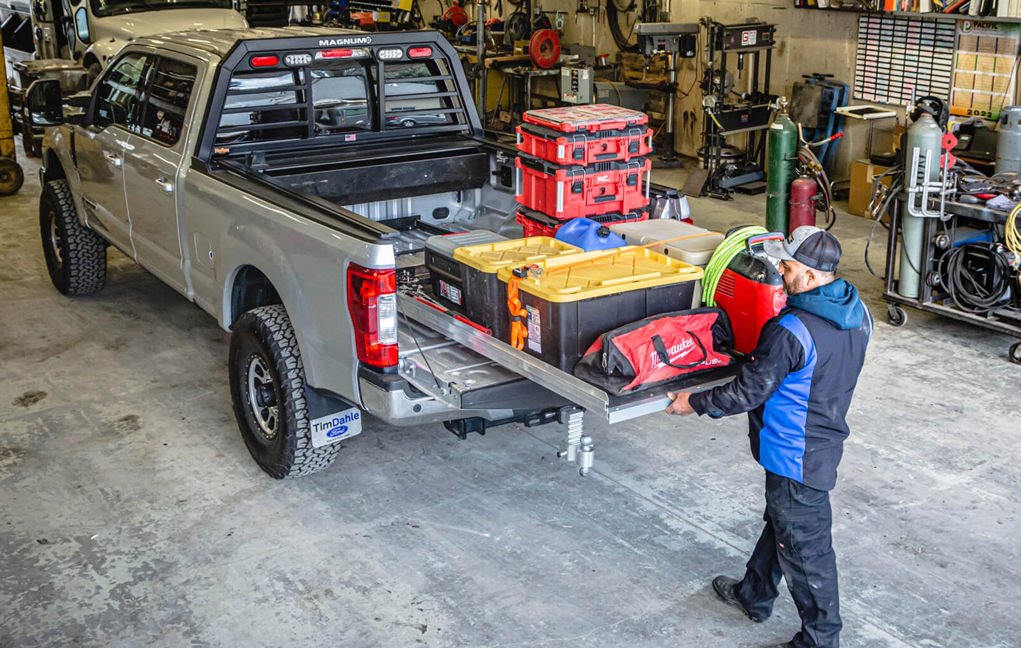 Man pulling out a cargoglide loaded down with tools in an auto shop