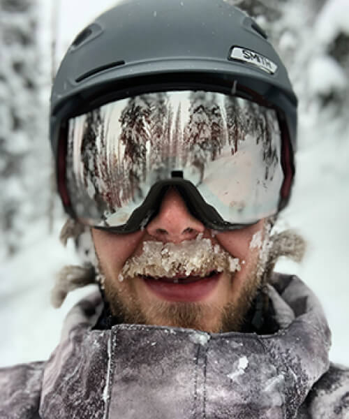 Man smiling while skiing