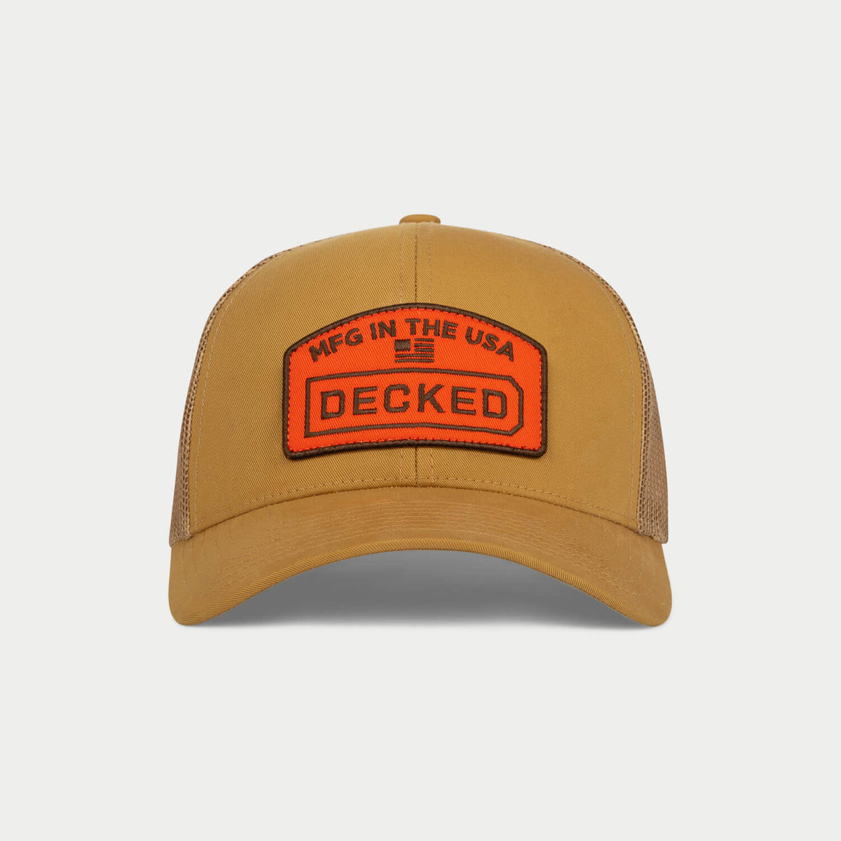 [H0777-TMFG-CYT] Front view of a coyote-tan trucker hat with an orange 'MFG in the USA' DECKED patch and matching mesh back.
