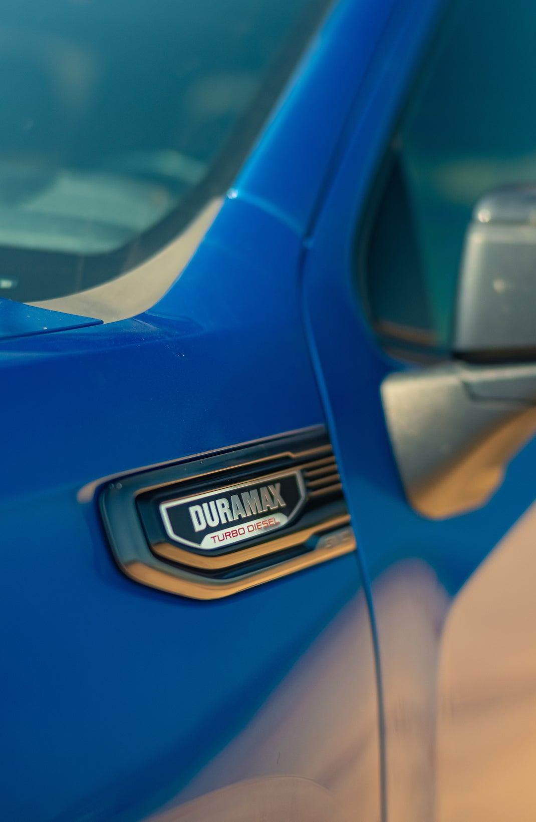Close-up of the Duramax Turbo Diesel badge on Thor Rippey’s blue truck.