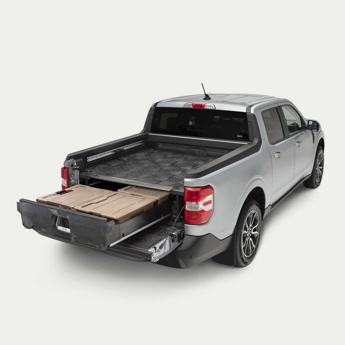 Side angle view of a Drawer System installed in a Maverick with the drawer open and one Sixer and two Halfracks inside.