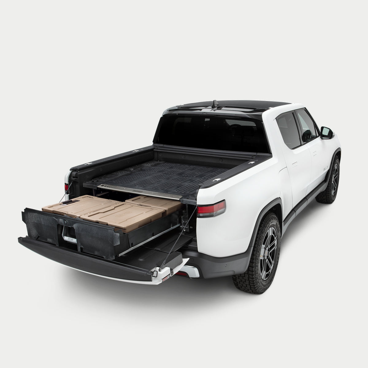 Side angle view of a Drawer System installed in a Rivian R1T with the drawer open and a Halfrack, and two Payloader D-co cases inside.