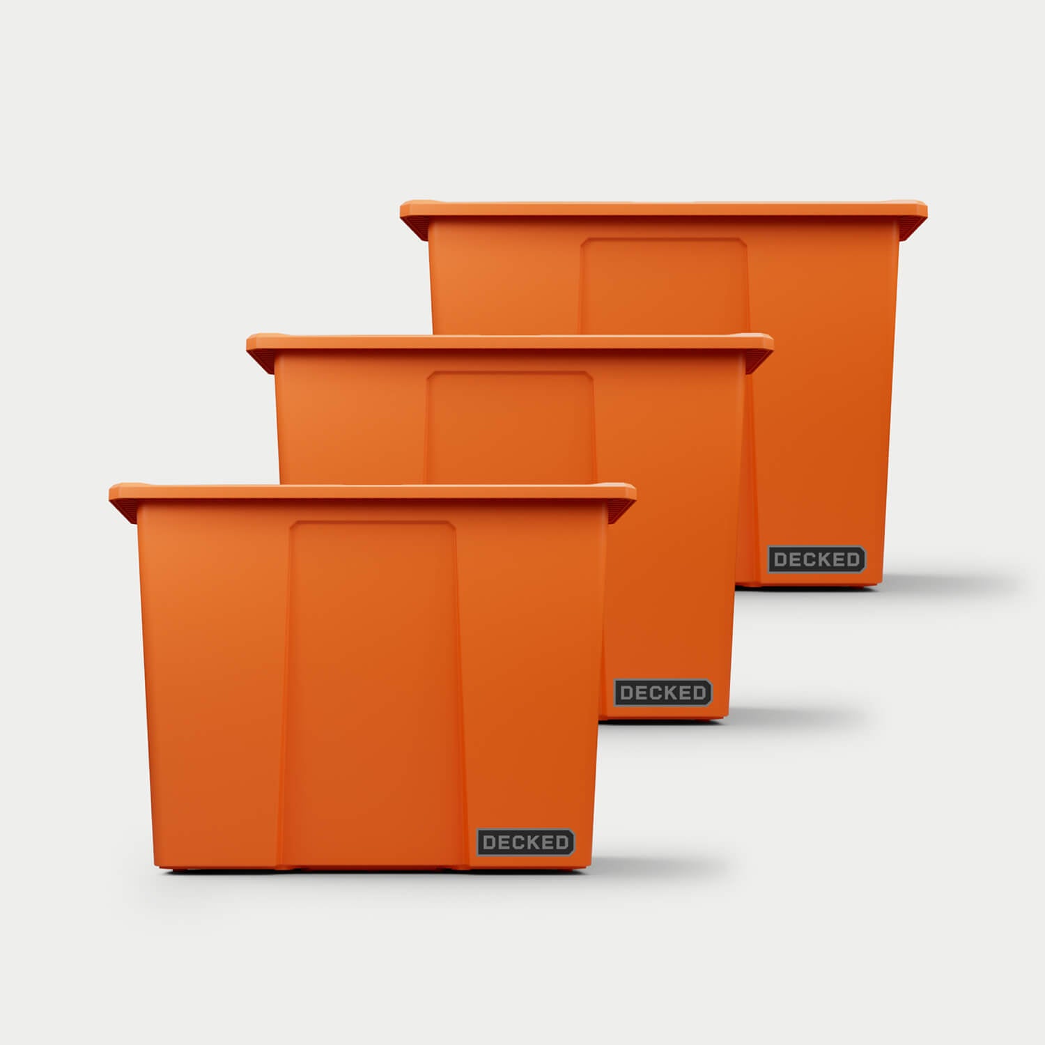 Three blaze orange Payloader 64 bins, closed on a white background, staggered diagonally.