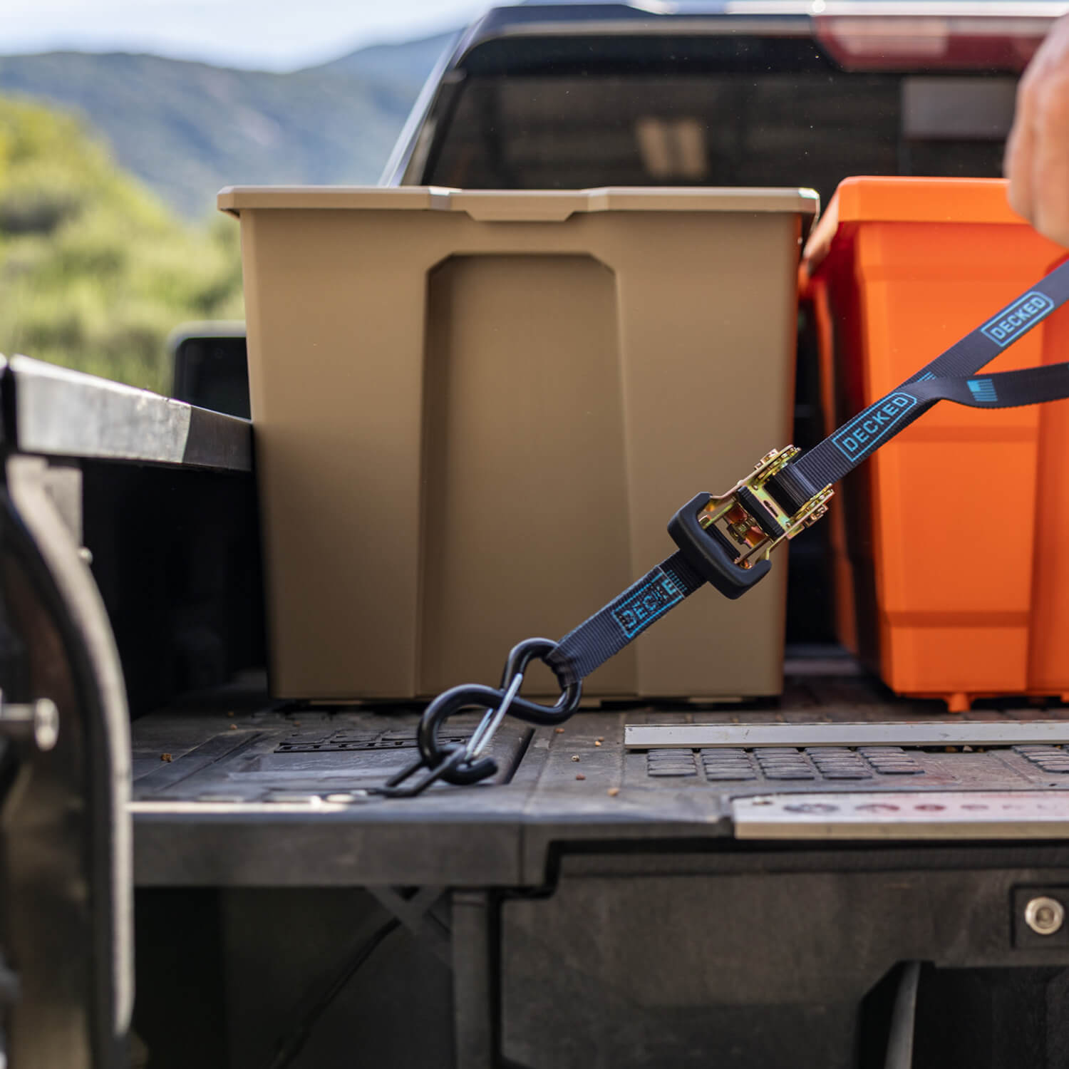 A desert tan Payloader Bin sitting on the deck of a Drawer System in the bed of a truck.