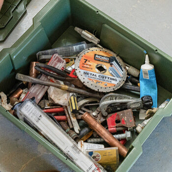 Desert Tan Payloader 32 with various tools and a metal cutting disc inside