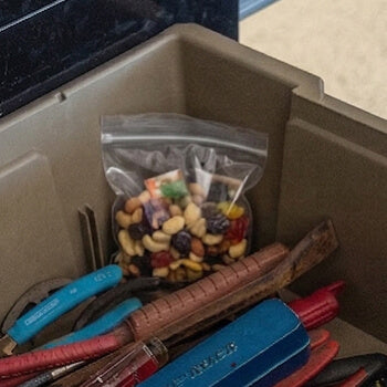 Close-up of a Payloader 32 with tools and a bag of mixed nuts.