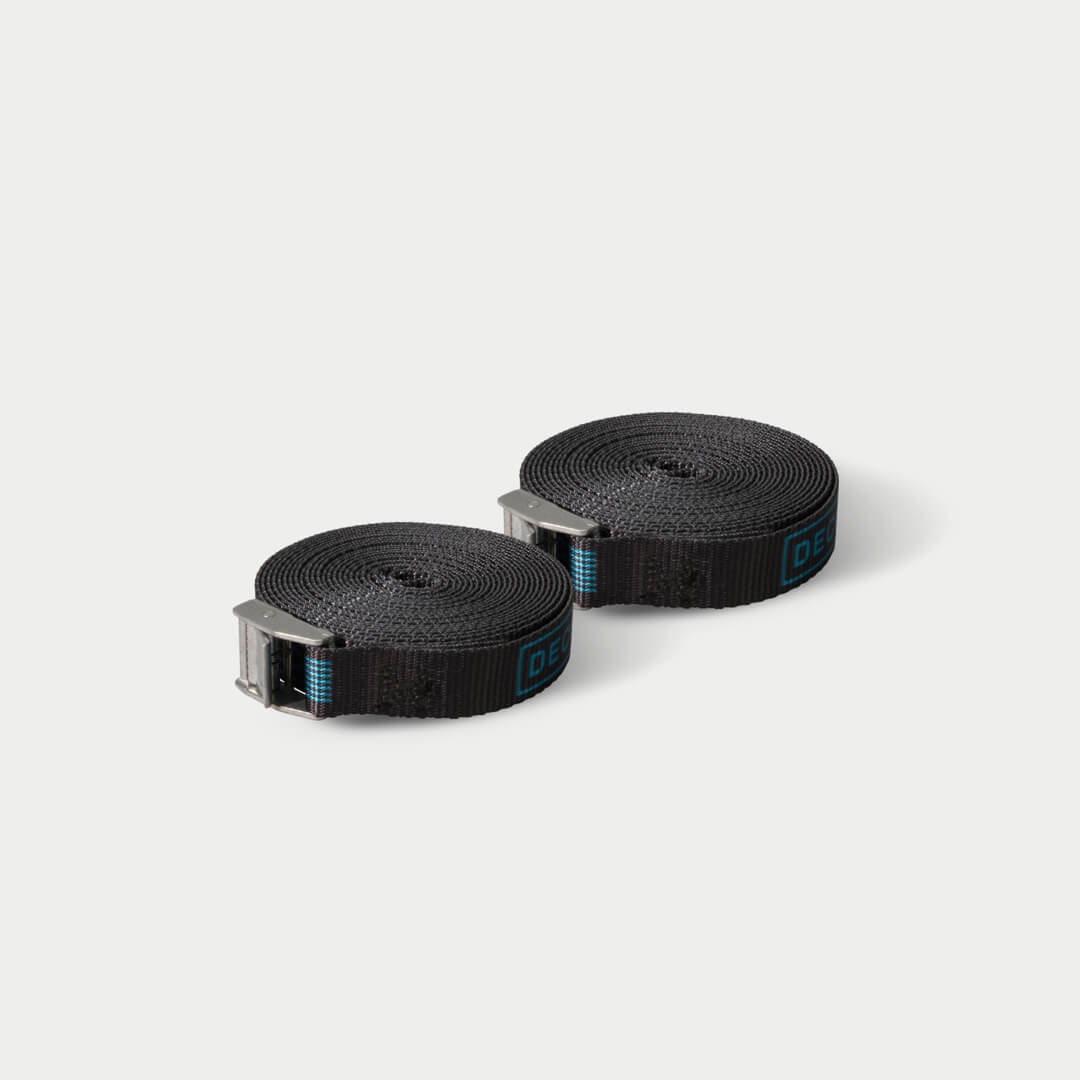 [A0089-CSTP-BLK] Black Cam Straps on grey background.