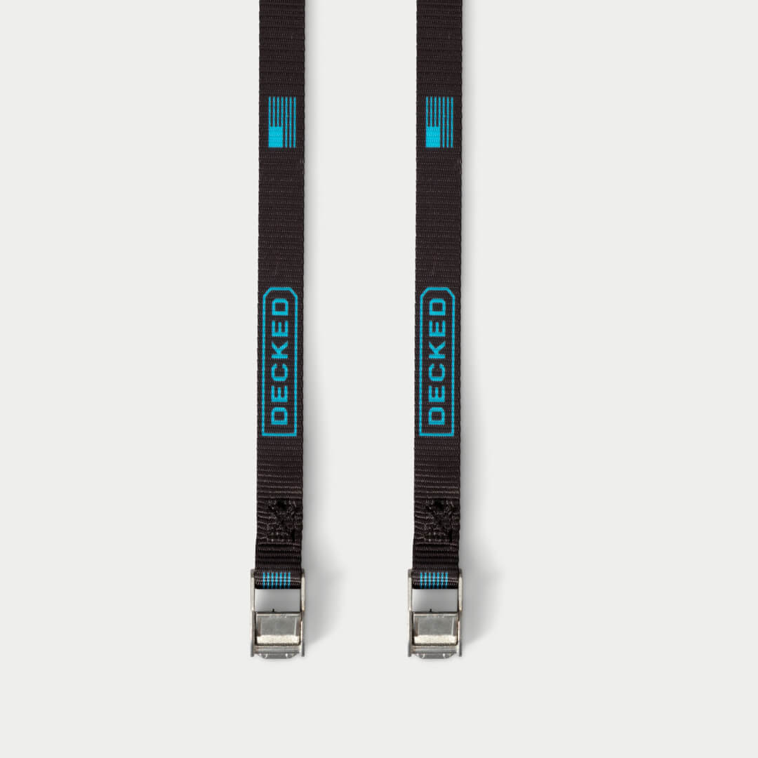 Black Cam Straps on grey background.