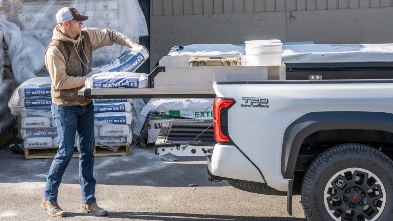 A man loading bags of mortar mix onto his CargoGlide slide system.