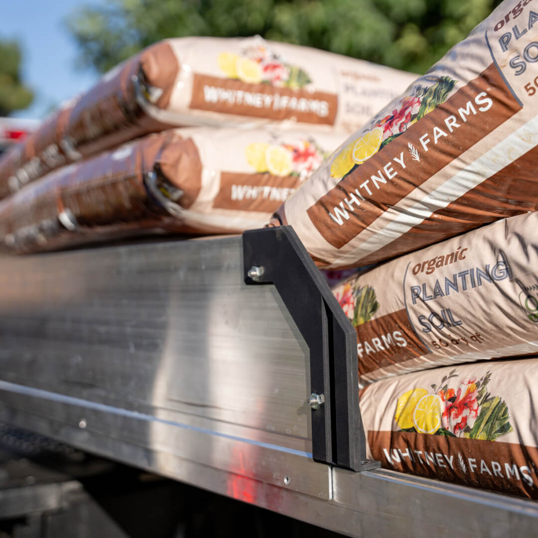 A CargoGlide with high sides stacked with planting soil bags.