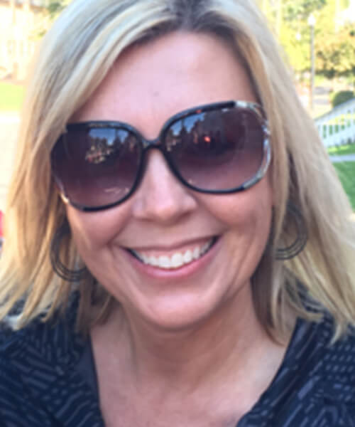 Woman smiling wearing sunglasses