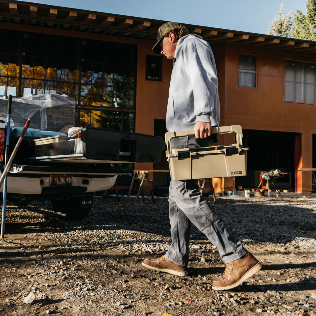 Man carrying a Sixer 16 around a construction jobsite