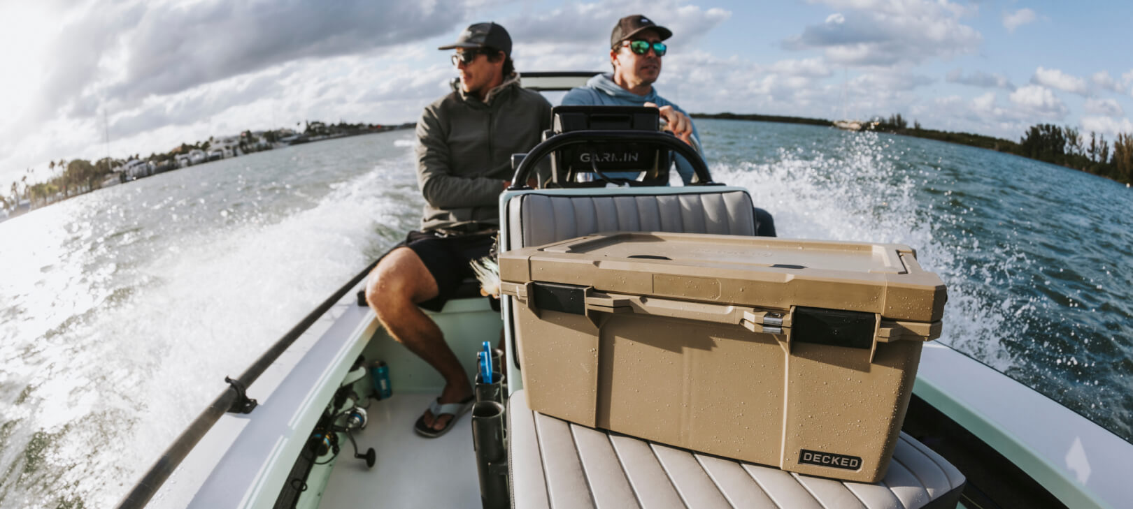 Two men headed out to fish in their boat, in front of them sits a Halfrack D-co Case that carries all of their tackle for the day.