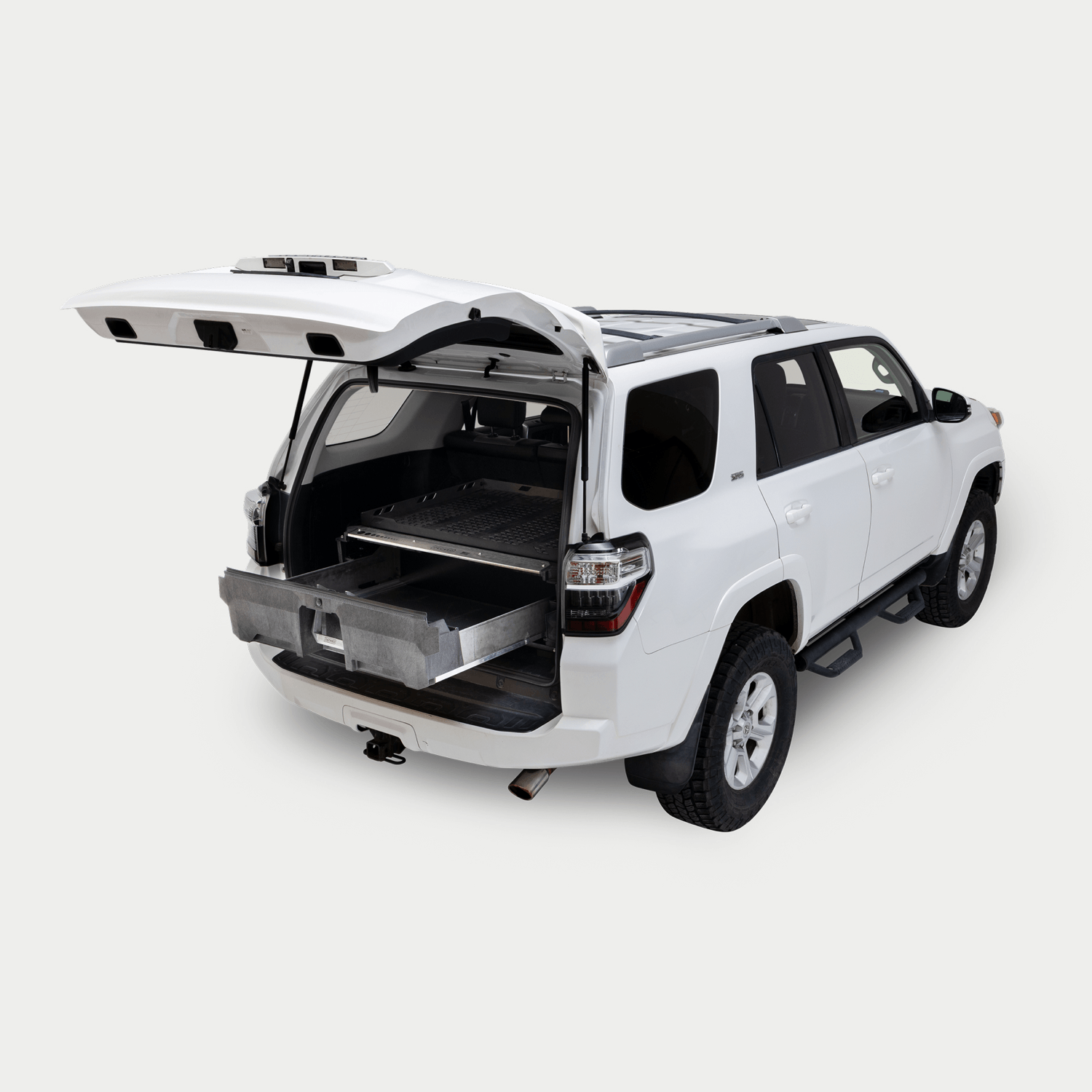 A white 5th Generation Toyota 4Runner on a white background with a Drawer System installed in the cargo area. The Drawer System is extended and shows the interior storage space.