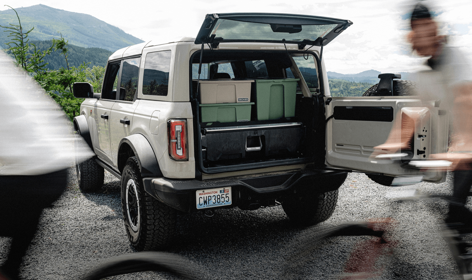A DECKED Drawer System with DECKED cases and bins stacked on top in the back of a Ford Bronco up in the mountains.