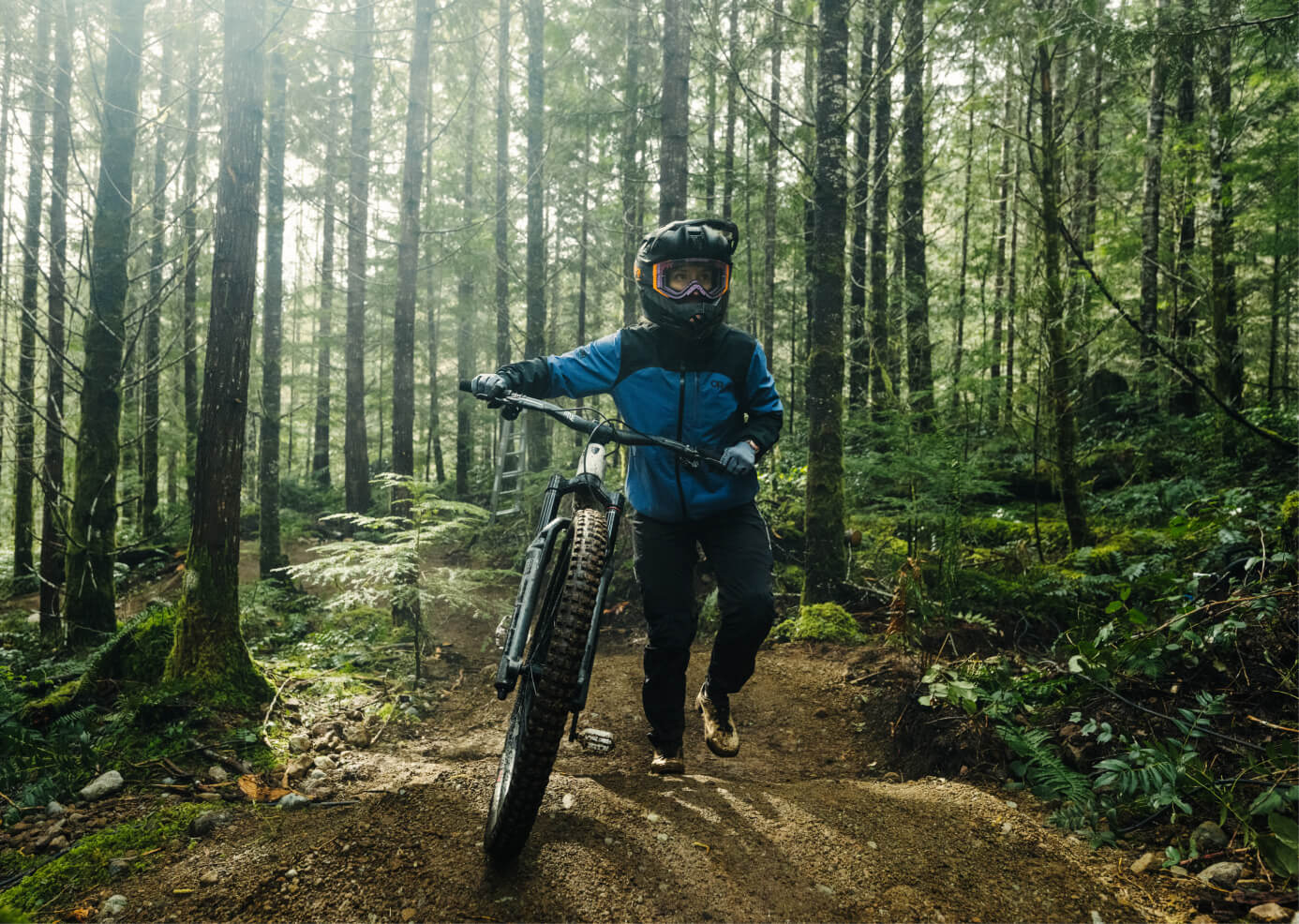 Casey Brown in the forest with her mountain bike.